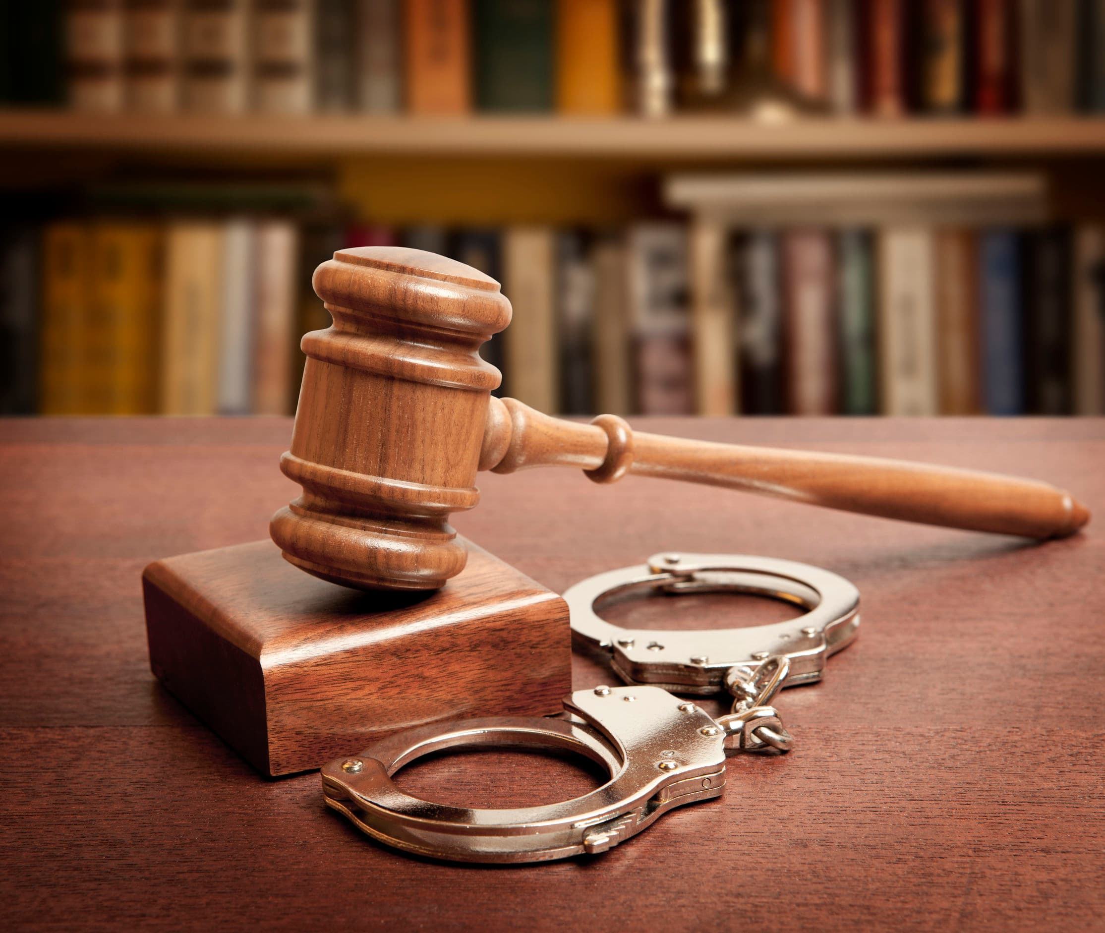 49176695 – gavel and handcuffs on wooden background
