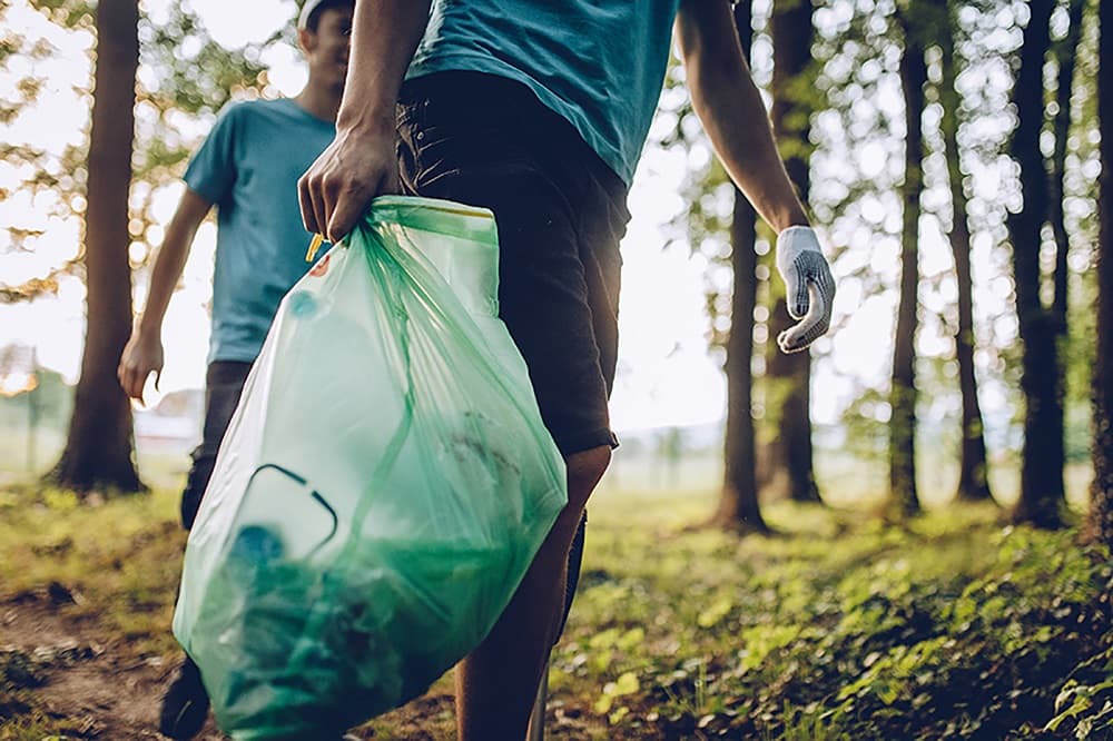 Group of volunteers collecting garbage in park
