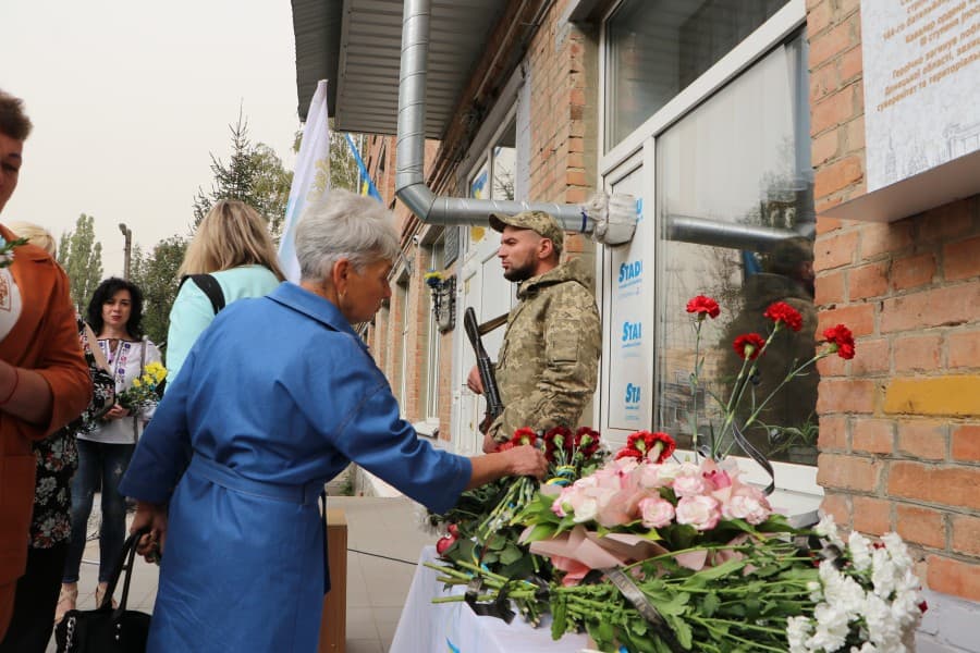 Люди кладуть квіти до меморіальної дошки. Фото: Полтавська міська рада.